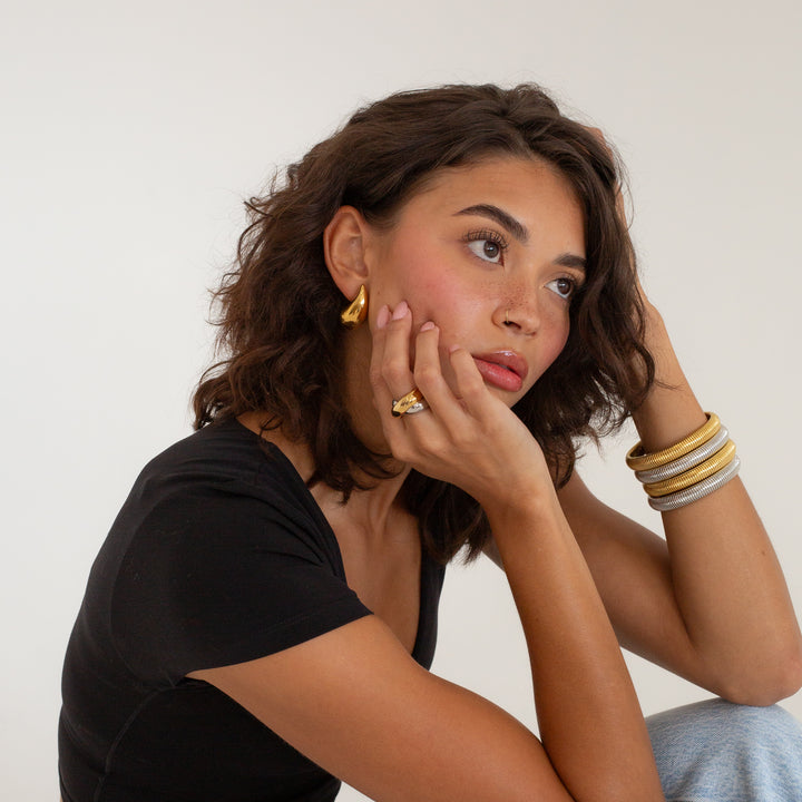 model wearing on finger mixed metal gold and silver crossover ring