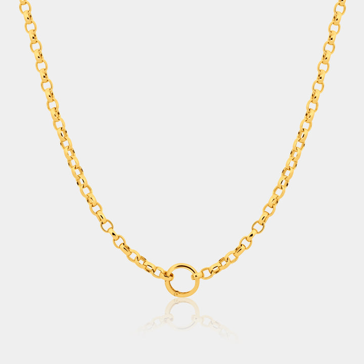 Gold chain necklace with a small round pendant on a light gray background
