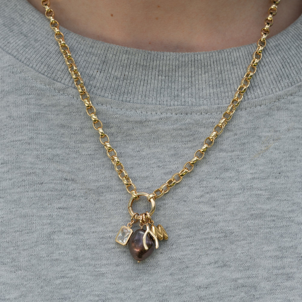 Gold-filled rolo chain necklace with some pendants on a person