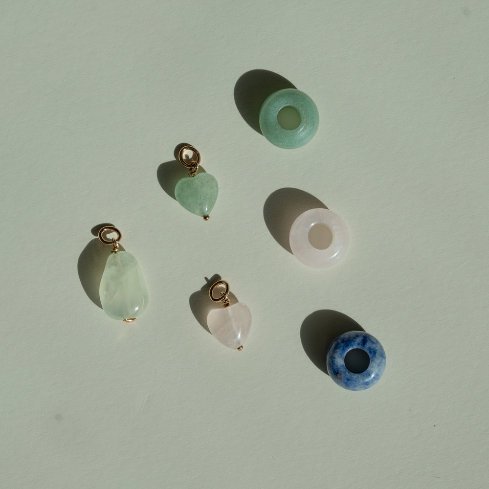 Set of crystal pendants on a light beige background