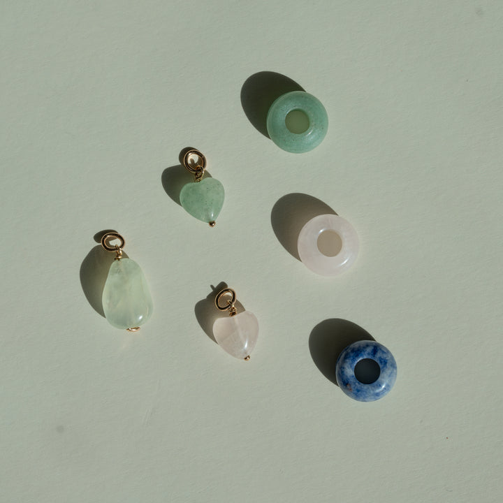 Set of crystal pendants on a light beige background
