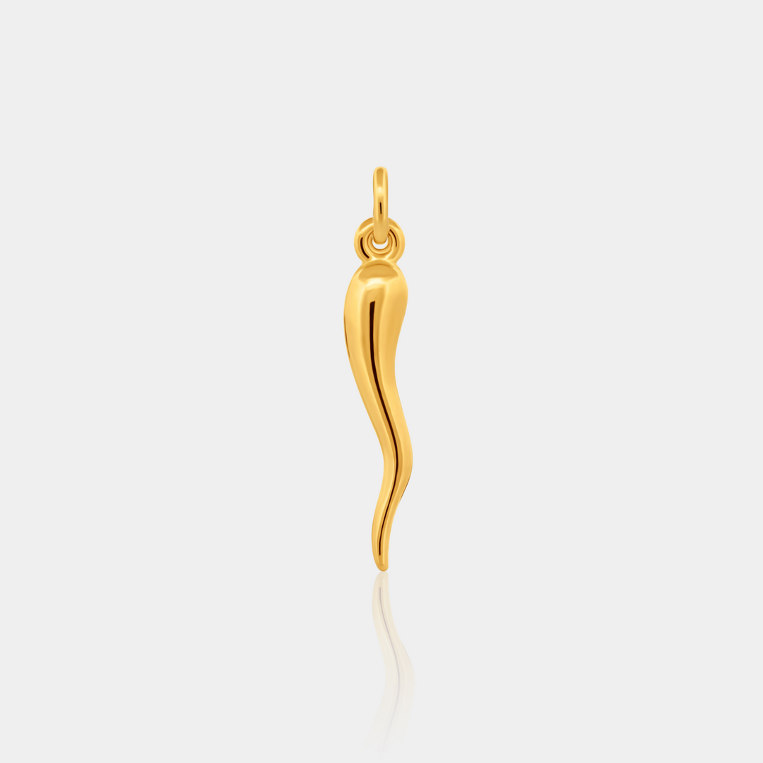 Gold Cornicello Horn Charm on light background