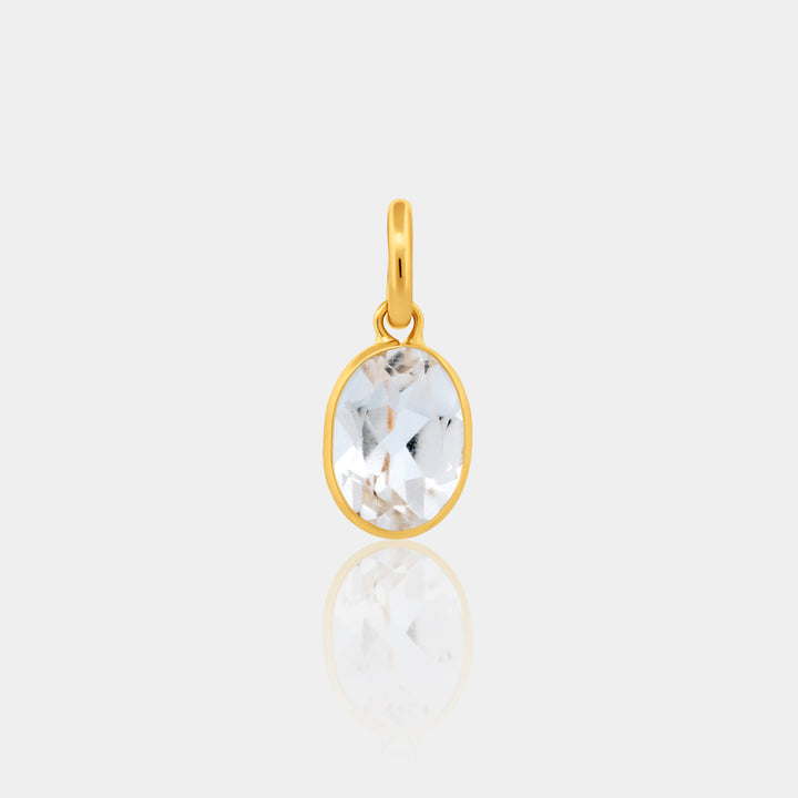 Gold Oval Bezel Set pendant with a clear gemstone on a light gray background