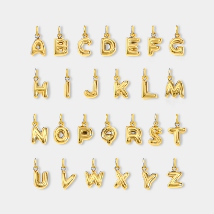 Gold letter pendants from A to Z on a white background