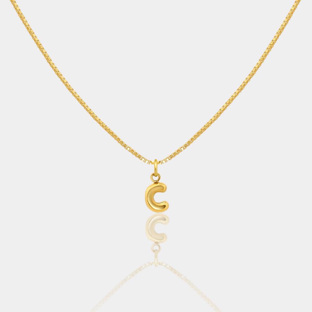 Gold necklace with a letter "C" Initial pendant on a white background