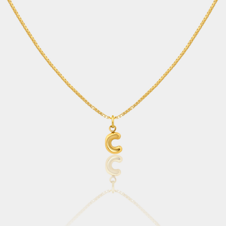 Gold necklace with a letter "C" Initial pendant on a white background