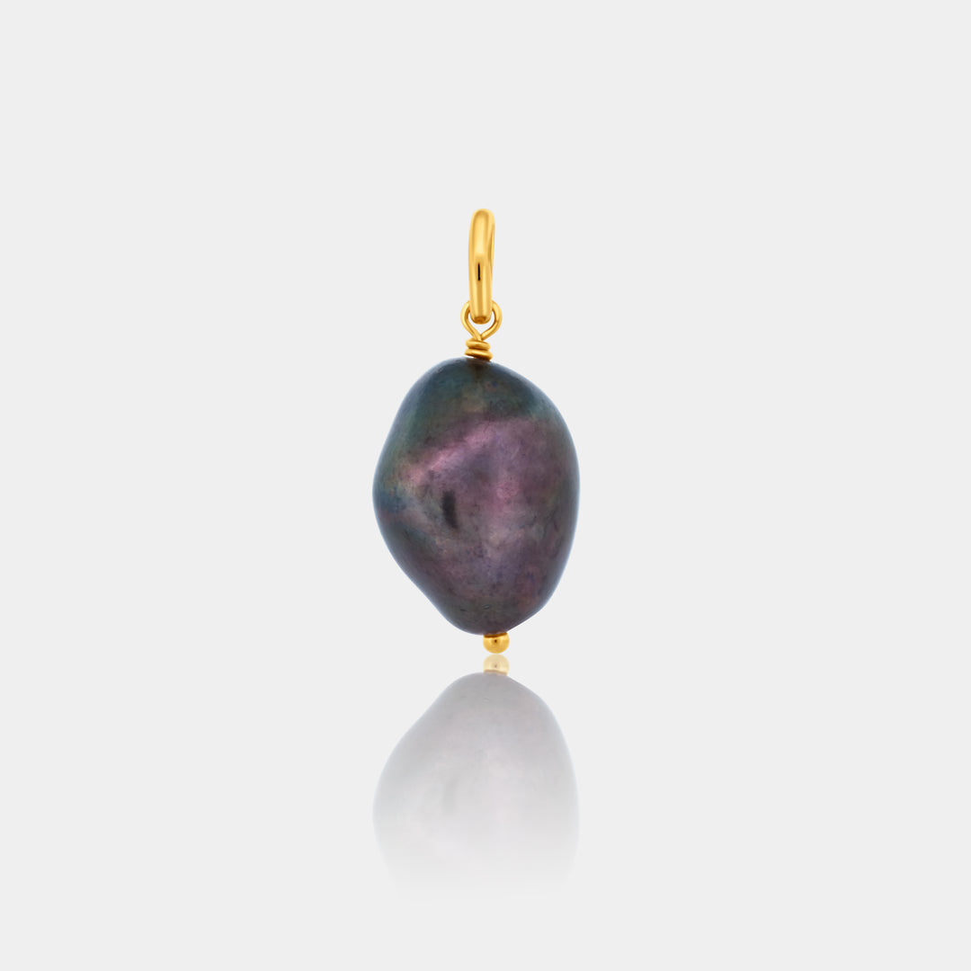 Dark Peacock Pearl pendant with gold accents on a light gray background