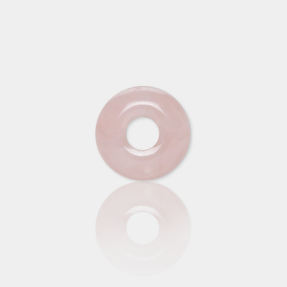rose quartz spacer bead on a light gray background