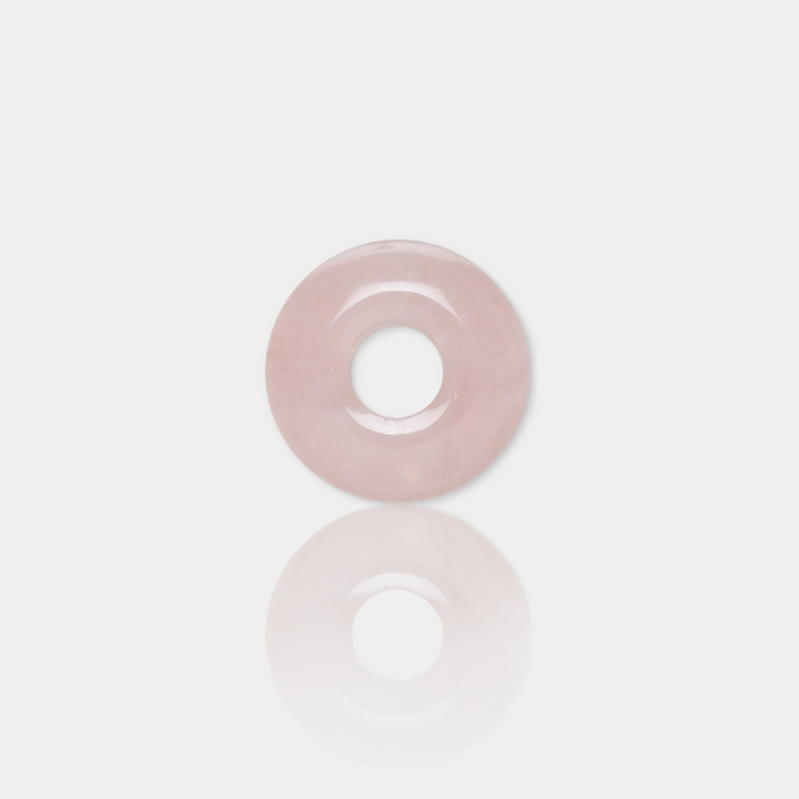 rose quartz spacer bead on a light gray background