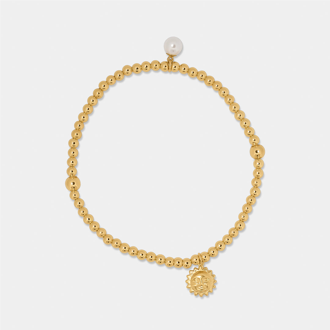 gold bead bracelet with sun and pearl charm