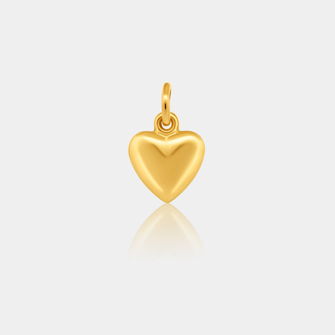 Gold heart-shaped pendant on a light gray background