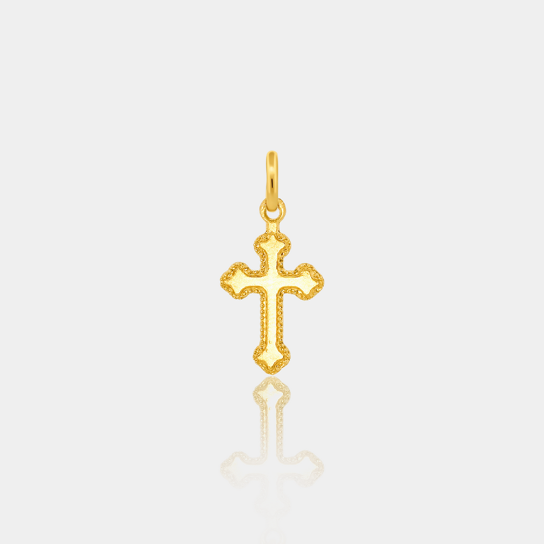 Gold cross pendant on a light gray background