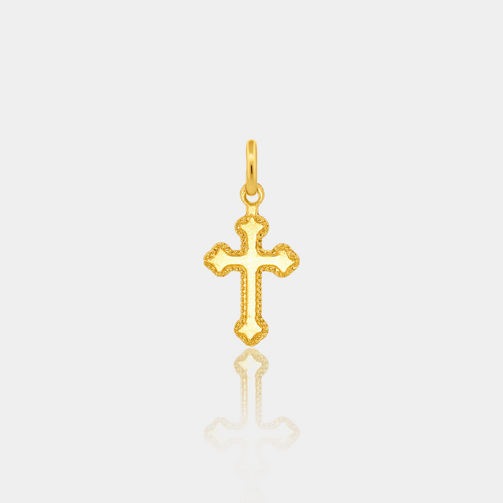 Gold cross pendant on a light gray background